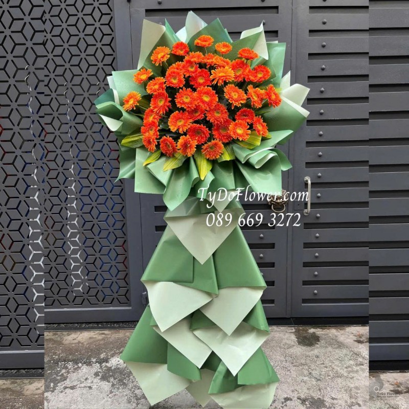 KCM0126023 KỆ HOA CHÚC MỪNG Thiết kế hoa đồng tiền cam